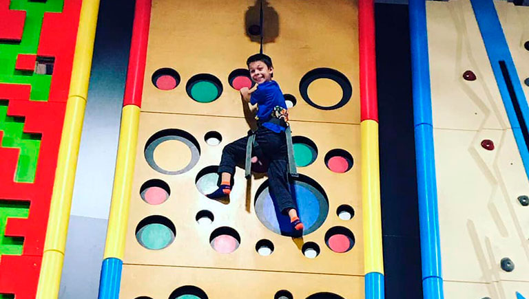 Boy On Climbing Wall